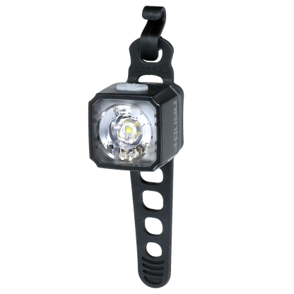 The CATEYE NANO100 F is a compact black bike light with a clear lens, offering 100 lumens and a silicone strap with multiple holes for adjustable attachment, shown against a white background.