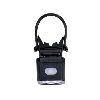 The CATEYE NANO60 is a small, black, square LED bike light with a flexible rubber strap for easy mounting. It’s USB-C rechargeable, features a white front button, and serves as a daytime visible safety light.