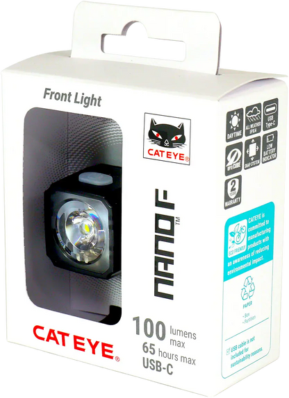 A white box with a cut-out window displays the CATEYE NANO100 F, a 100-lumen bike light. The packaging highlights up to 65 hours runtime, USB-C recharging, and use of eco-friendly materials.